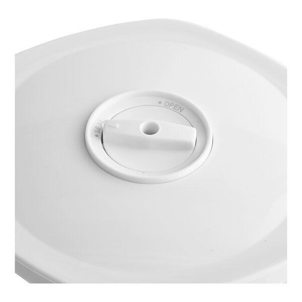 A white plastic lid for a Galaxy vacuum canister with a round hole.