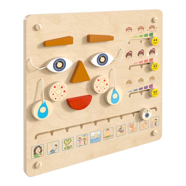 A wooden board with different faces and shapes on it.