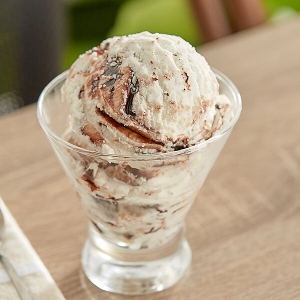 A glass with a scoop of I. Rice Chocolate Fudge Variegate ice cream.