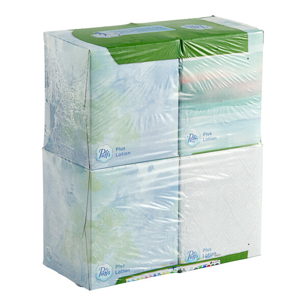 A stack of Puffs Plus Lotion facial tissue cubes in plastic.