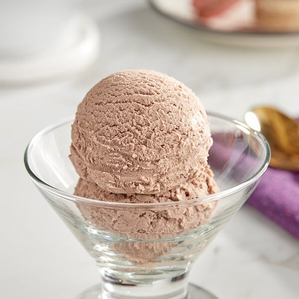 A scoop of I. Rice Butter Fudge hard serve ice cream in a glass bowl.