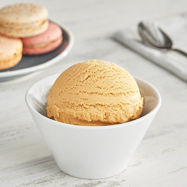 A bowl of I. Rice salty caramel hard serve ice cream with a scoop of ice cream on top.