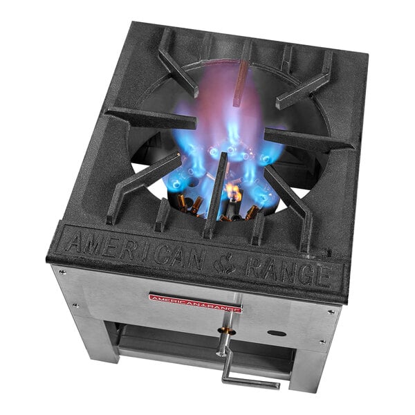 An American Range black stock pot stove with a blue flame.