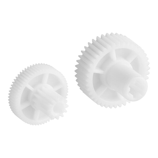 A close-up of a couple of white plastic gears with a nut.