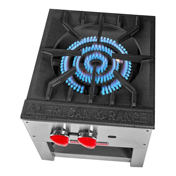 An American Range black liquid propane stock pot stove with blue flames.