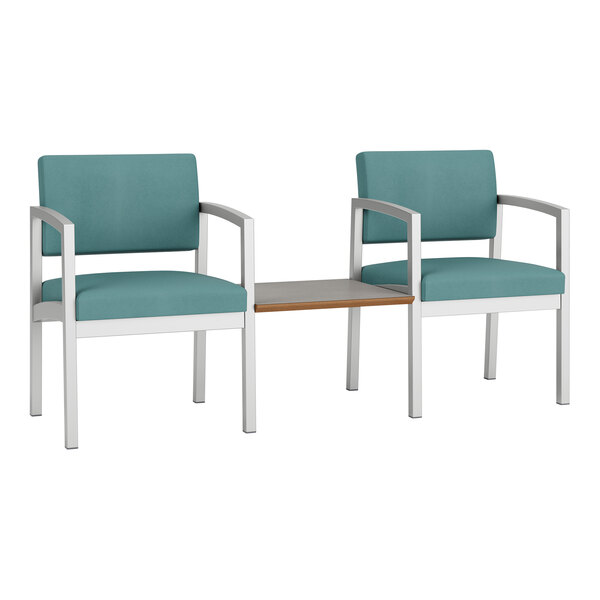 Two blue Lesro Lenox chairs with a table.