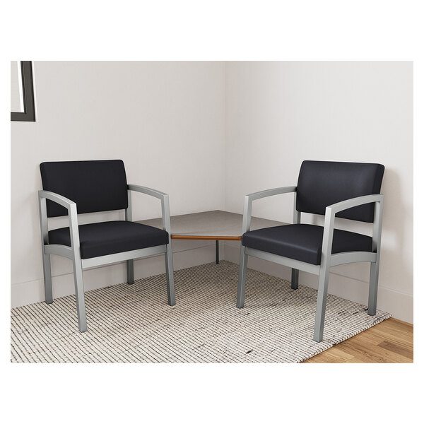 Two Lesro Lenox black vinyl arm chairs with a Sarum Twill laminate connecting corner table.