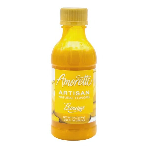 A close-up of a yellow bottle of Amoretti Banana Artisan Natural Flavor Paste with white text on the label.