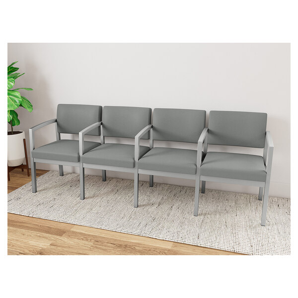 A row of Lesro Lenox steel open house asteroid fabric grey chairs with armrests.
