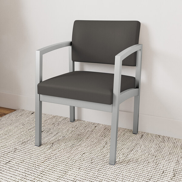 A Lesro Lenox steel guest arm chair with black vinyl cushion.