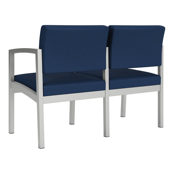 A Lesro Lenox navy blue loveseat with center arm and chrome legs.
