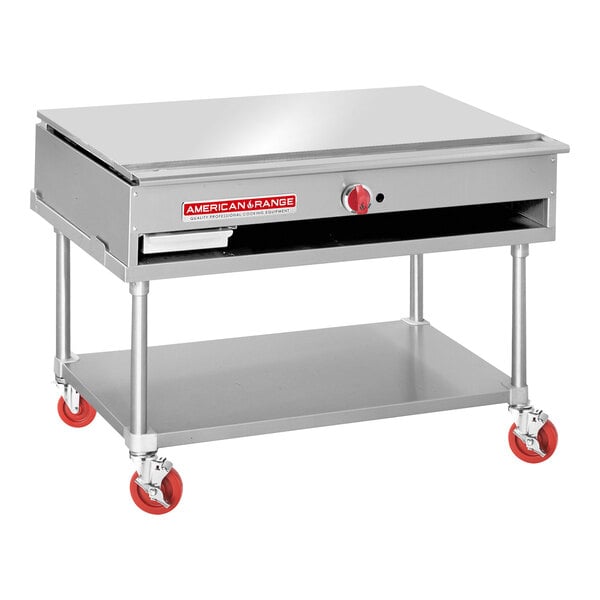 An American Range stainless steel Teppanyaki griddle on a stainless steel table with red wheels.