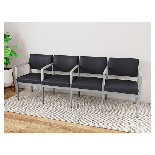 A Lesro Lenox black steel sofa with center arms and black vinyl seats.