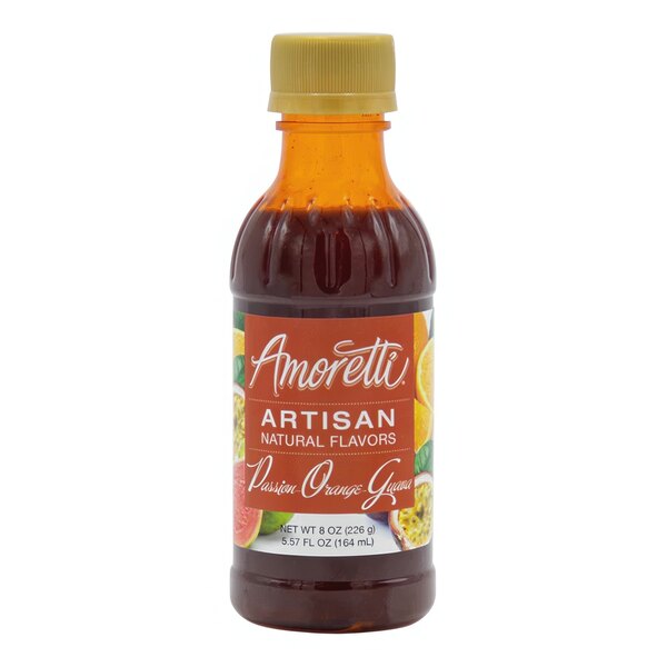 A bottle of Amoretti Passion Orange Guava artisan flavor paste on a counter with a label.