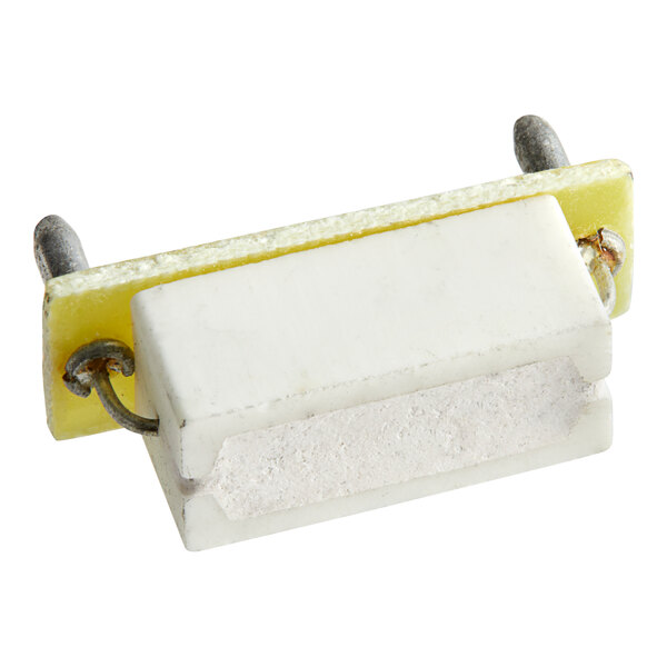 A white and yellow Estella Auto-Feed Board Resistor with metal clips.