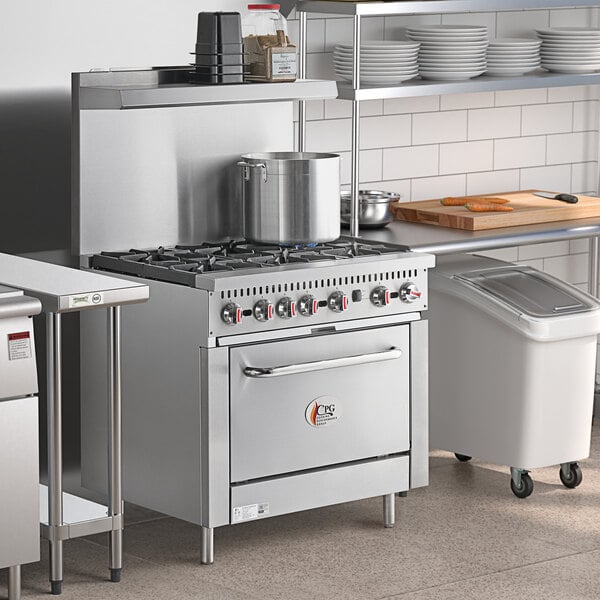 A large stainless steel Cooking Performance Group range with an oven on a counter in a professional kitchen.