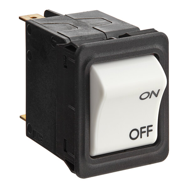 A close-up of a black and white Estella thermal protection switch with a white button.