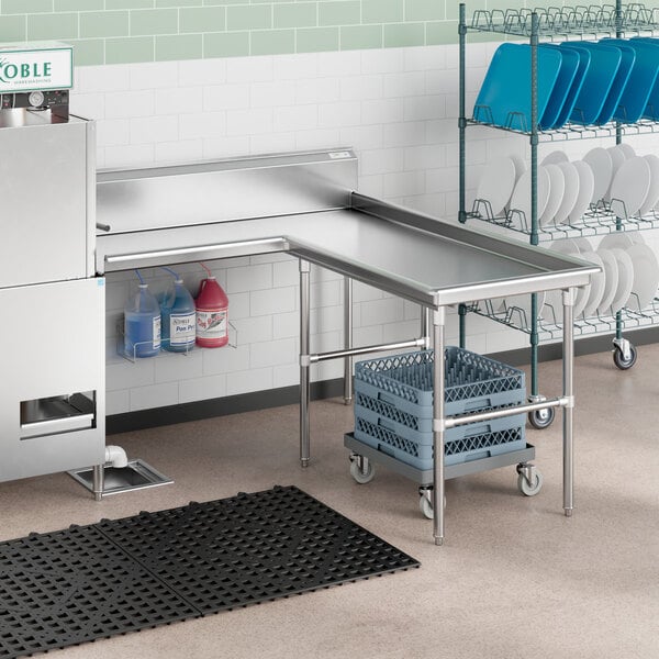 A Regency stainless steel L-shape dishtable on a stainless steel counter.