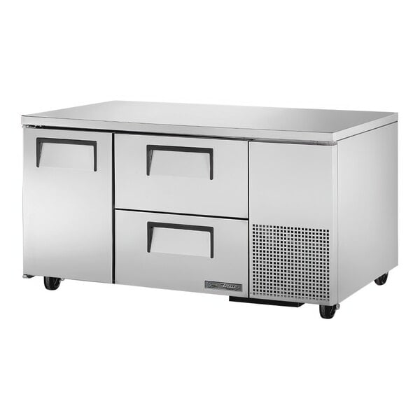 A silver True undercounter refrigerator with drawers.