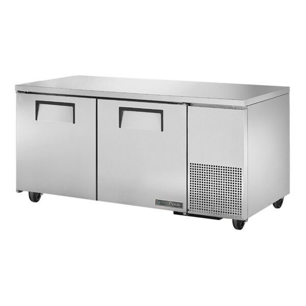 A stainless steel True undercounter freezer with two doors.