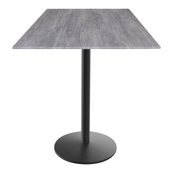 A Holland Bar Stool EuroSlim counter height table with a black base and grey top on a black pole.