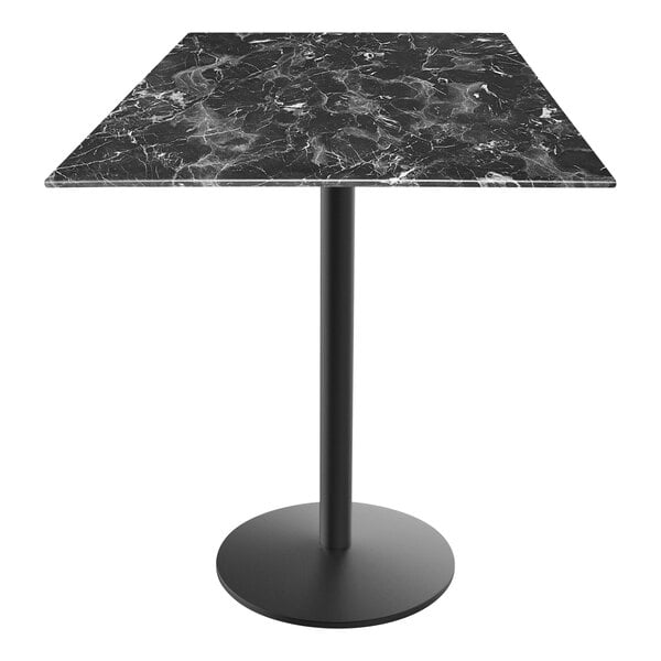 A Holland Bar Stool black marble counter height table with a round metal base.
