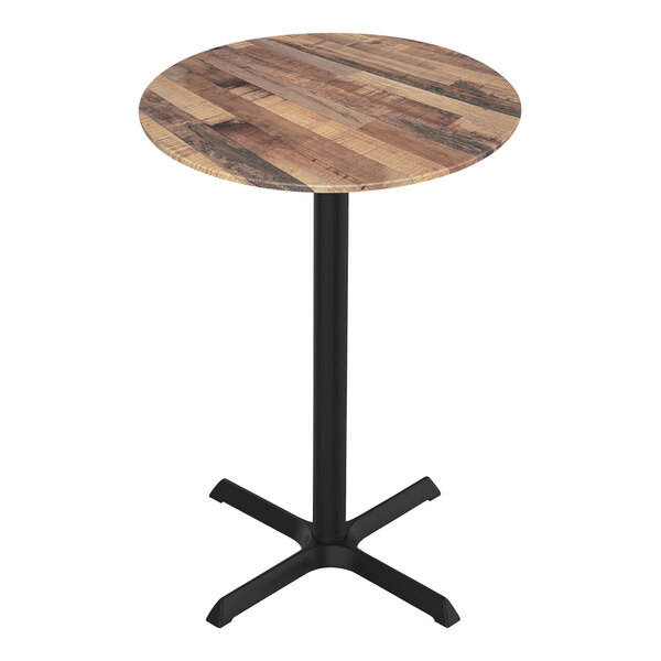 A round wooden Holland Bar Stool EuroSlim table with a black metal cross base.