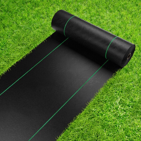 A roll of SEALTECH black landscape fabric on grass.