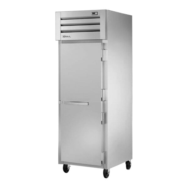 A silver True Spec Series reach-in refrigerator with a white door and a handle on wheels.