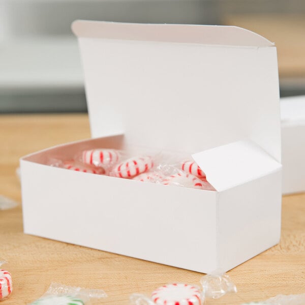 A Baker's Lane 1/2 lb. white candy box on a table.