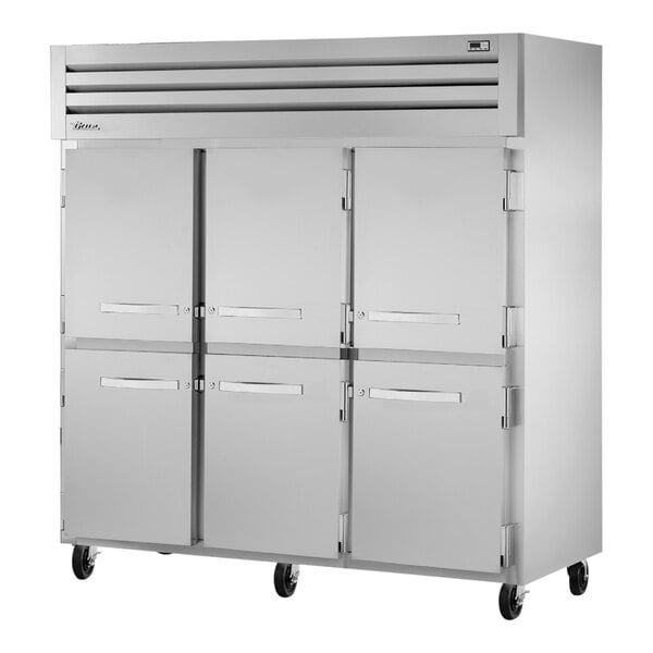 A large silver True Spec Series reach-in refrigerator with white cabinet and silver half doors.