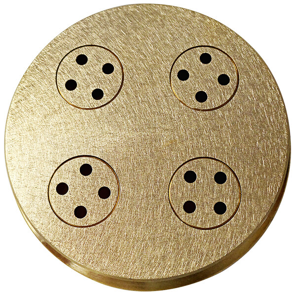 A gold circular Sirman bigoli pasta die with black holes.