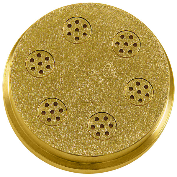 A gold circular Sirman #9 Spaghetti pasta die with holes in it.