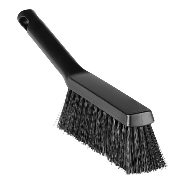 A close-up of a black bench brush with medium bristles.