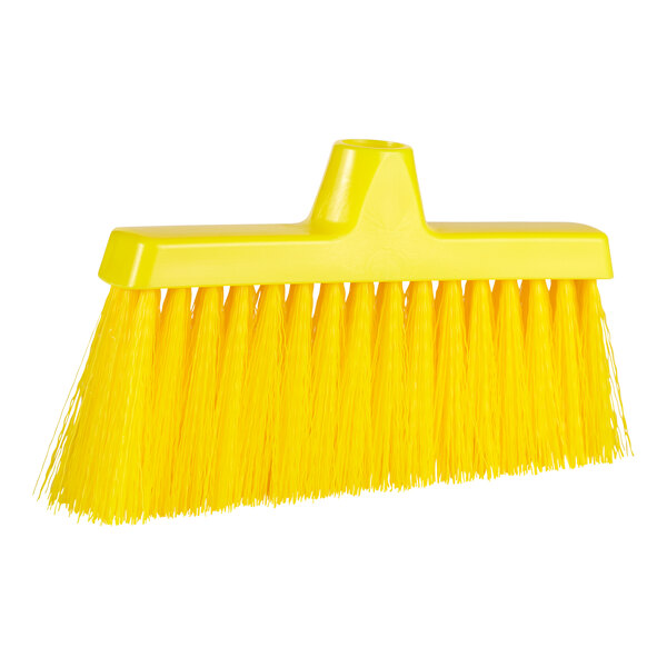 A yellow broom head with long bristles.