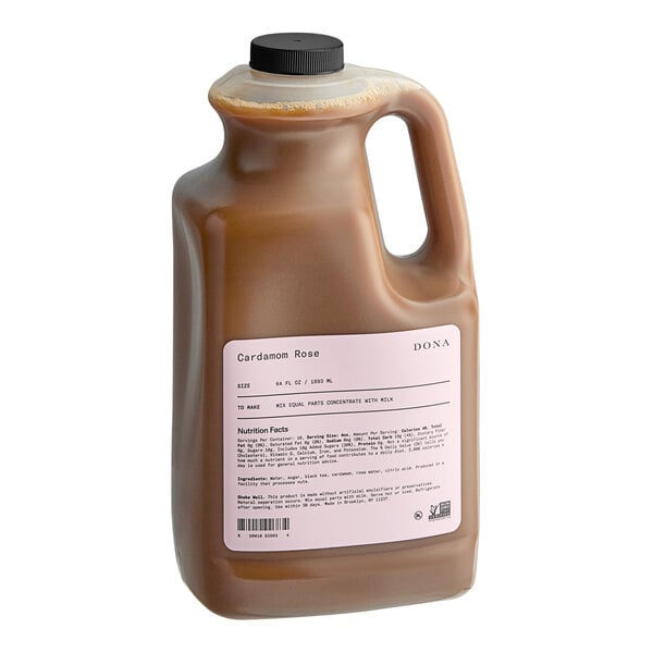 A jug of Dona Cardamom Rose Tea Concentrate, a brown liquid.