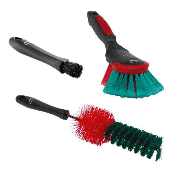 A Vikan 3-piece campaign brush set with red and green handles.