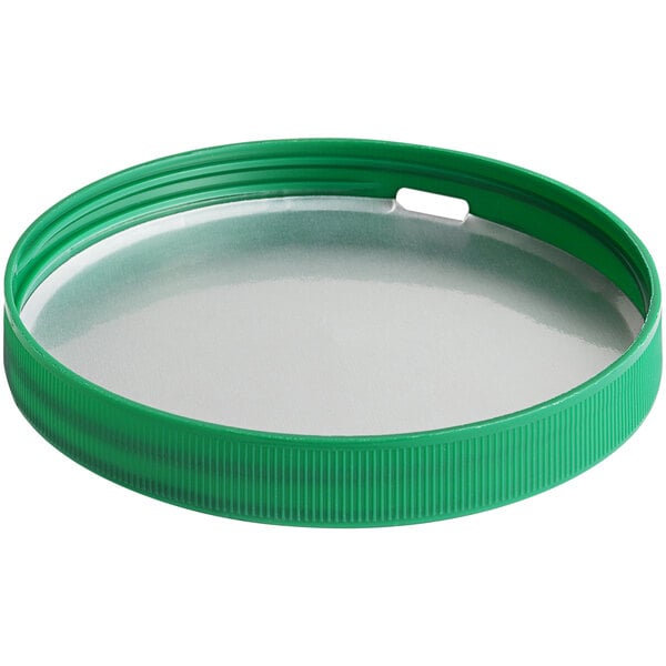 A green plastic lid with a metal rim.