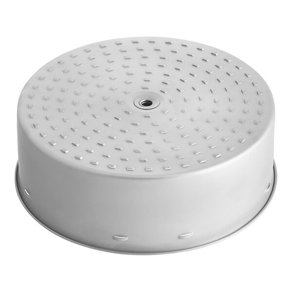 A silver circular brew basket with holes.