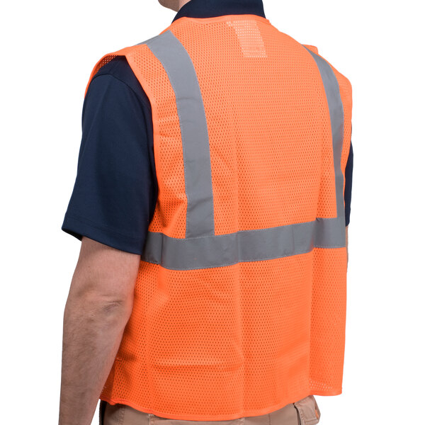 A person wearing a Cordova orange high visibility safety vest with reflective stripes.