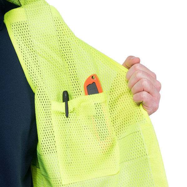 A man wearing a Cordova lime high visibility vest with a pen in the pocket.