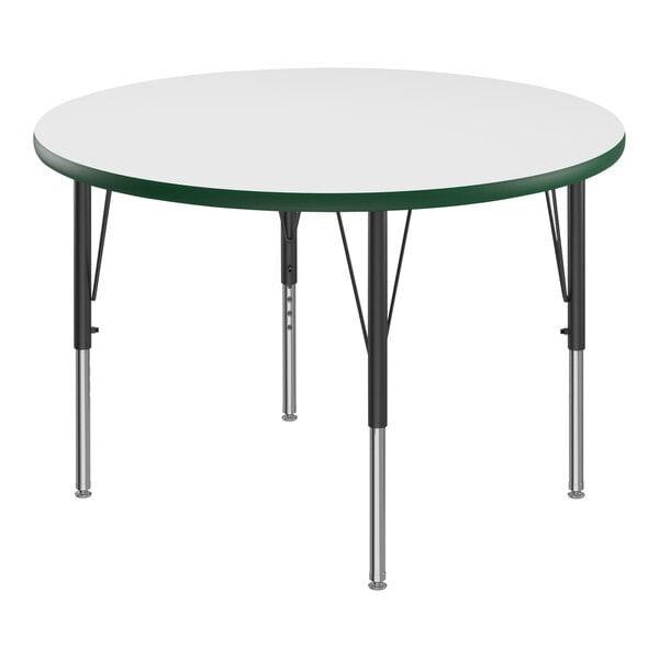 A white round Correll activity table with green T-molded legs.