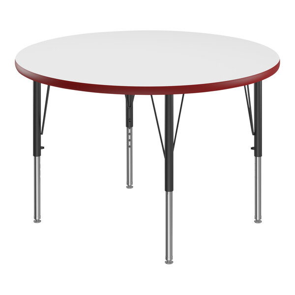 A white round Correll activity table with red T-Mold.