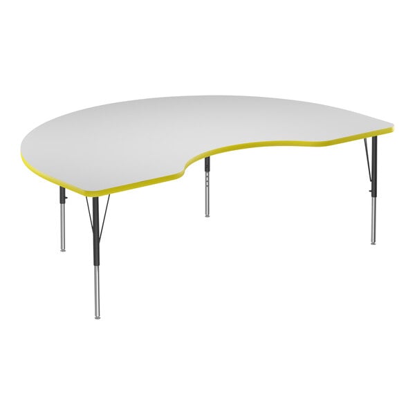 A white Correll activity table with a yellow edge in the shape of a kidney.