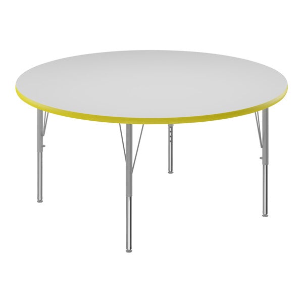 A white and yellow Correll round activity table with a dry erase board top.