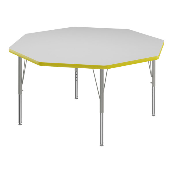 A white and yellow hexagon Correll activity table top with silver legs and yellow trim.