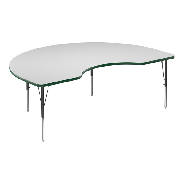 A white Correll kidney-shaped activity table with a green edge.