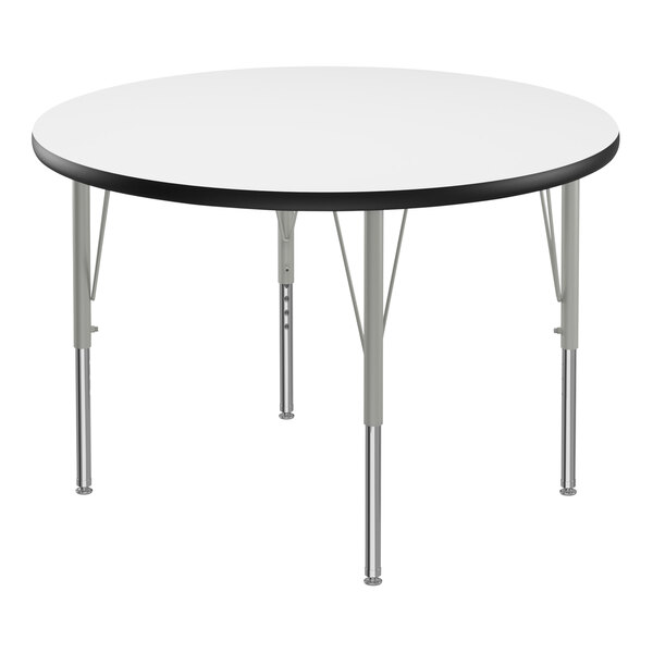 A Correll round activity table with a white top, black edge, and silver legs.