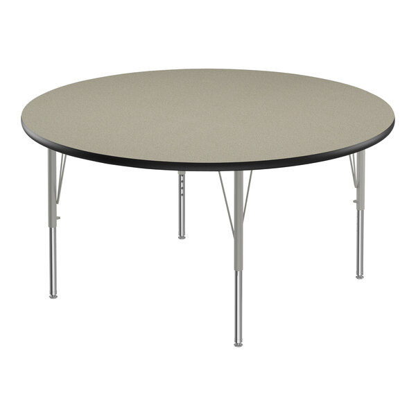 A round Correll activity table with metal legs and a black edge.