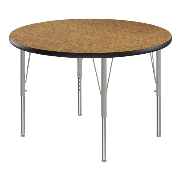 A Correll round activity table with medium oak top and silver legs.